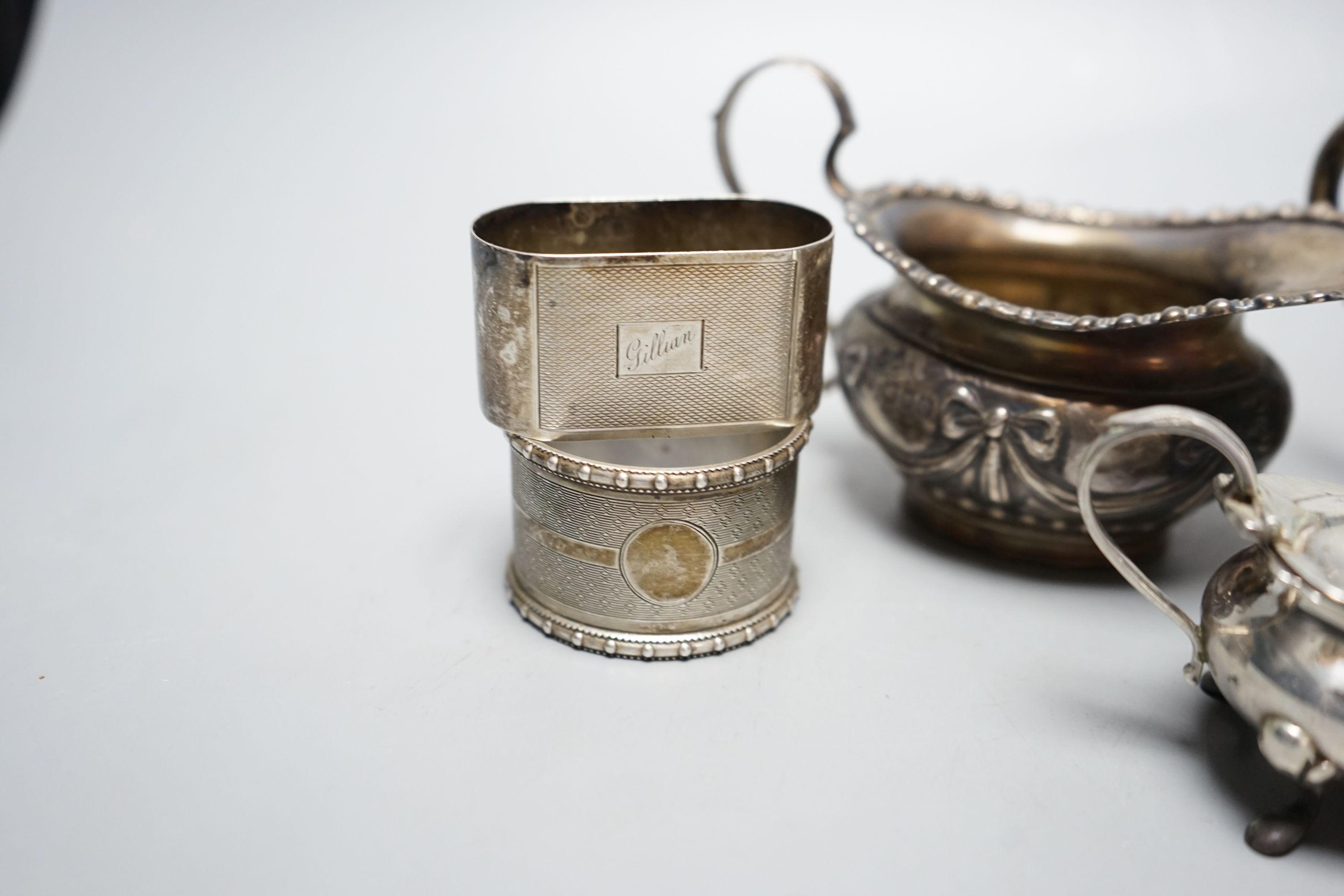 A late Victorian silver cream jug, London, 1900, a German 800 cream jug, a silver mustard pot, two silver napkin rings, a silver lid and a wooden box